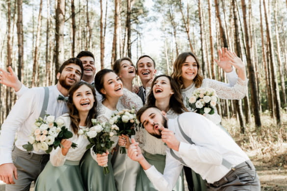 a wedding party throwing smiling with a bride and groom 